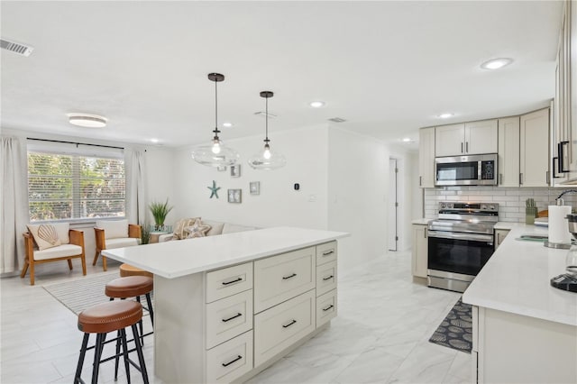 578-580 Companion Way, Longboat Key, FL 34228 - kitchen with stainless steel appliances, light countertops, a sink, visible vents, and a kitchen breakfast bar