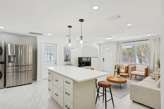 578-580 Companion Way, Longboat Key, FL 34228 - kitchen featuring recessed lighting, visible vents, stainless steel refrigerator with ice dispenser, and stacked washing maching and dryer