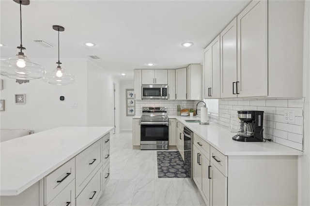 578-580 Companion Way, Longboat Key, FL 34228 - kitchen with stainless steel appliances, light countertops, backsplash, a sink, and visible vents