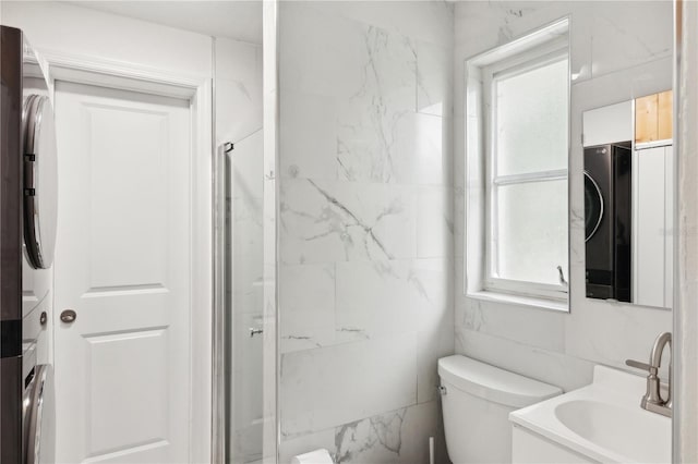 578-580 Companion Way, Longboat Key, FL 34228 - bathroom featuring stacked washer / dryer, a stall shower, toilet, and vanity