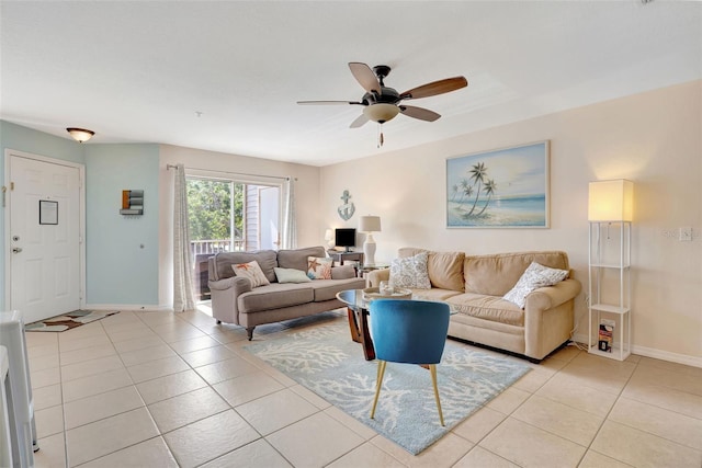 living area with baseboards, ceiling fan, and light tile patterned flooring