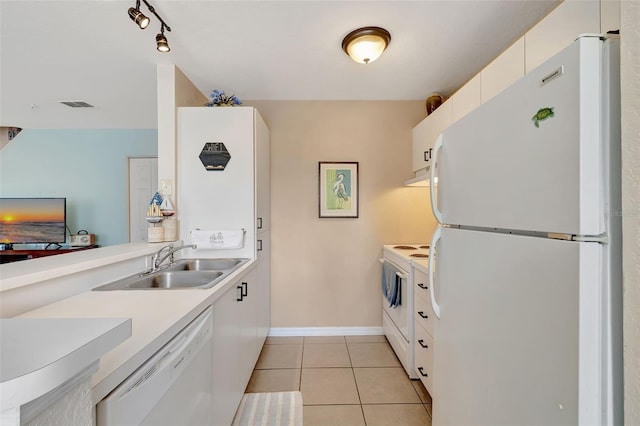 kitchen with a sink, visible vents, white appliances, under cabinet range hood, and light countertops