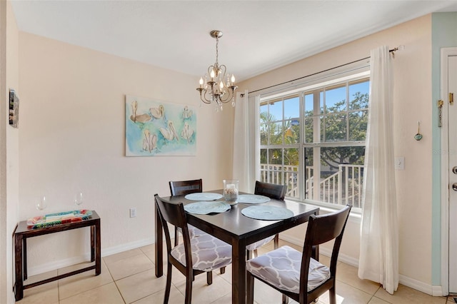 dining area featuring an inviting chandelier, light tile patterned flooring, and baseboards