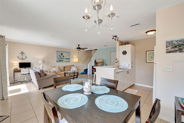 dining area featuring light tile patterned floors, baseboards, visible vents, and ceiling fan with notable chandelier
