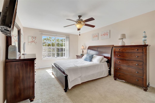 bedroom featuring baseboards, light carpet, and a ceiling fan