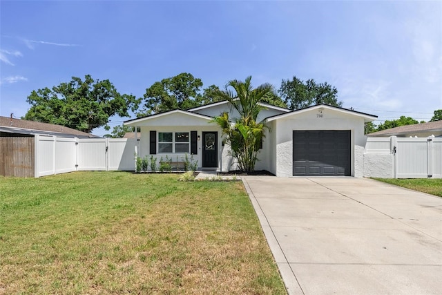 7141 37th Ave N, Saint Petersburg, FL 33710 - ranch-style home featuring fence, an attached garage, a front yard, a gate, and driveway