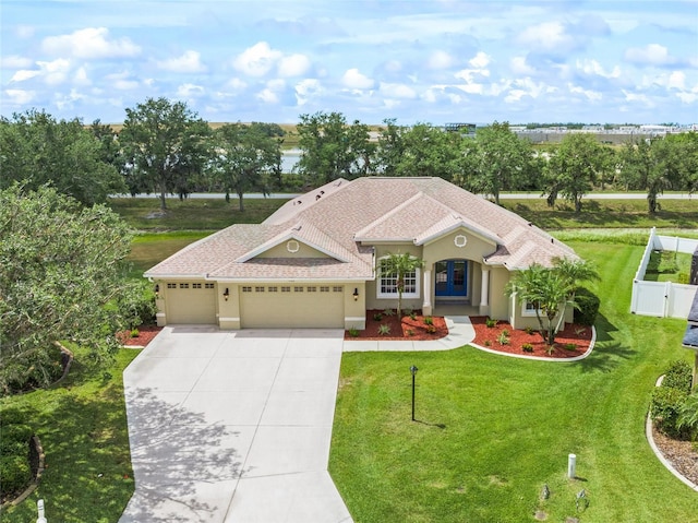 9106 Yarberry St, Sarasota, FL 34240 - view of front of house featuring concrete driveway, a front yard, an attached garage, and fence