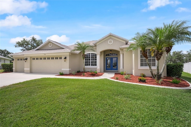 9106 Yarberry St, Sarasota, FL 34240 - view of front of home featuring an attached garage, french doors, concrete driveway, stucco siding, and a front yard