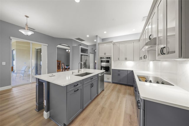 9106 Yarberry St, Sarasota, FL 34240 - kitchen featuring stainless steel appliances, light wood-style flooring, a sink, and gray cabinets