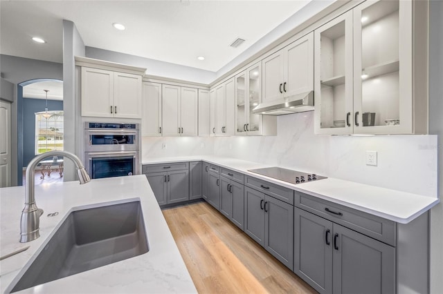 9106 Yarberry St, Sarasota, FL 34240 - kitchen featuring a sink, gray cabinets, visible vents, under cabinet range hood, and black electric stovetop