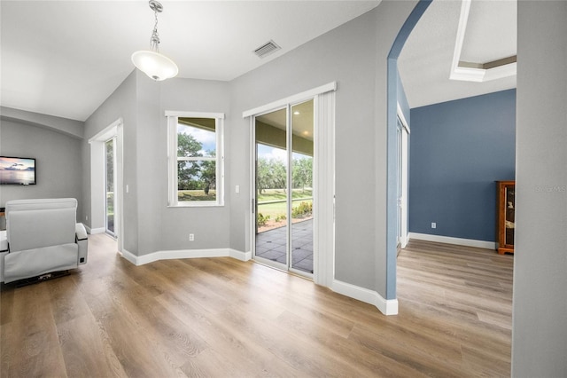 9106 Yarberry St, Sarasota, FL 34240 - entryway featuring arched walkways, baseboards, visible vents, and wood finished floors