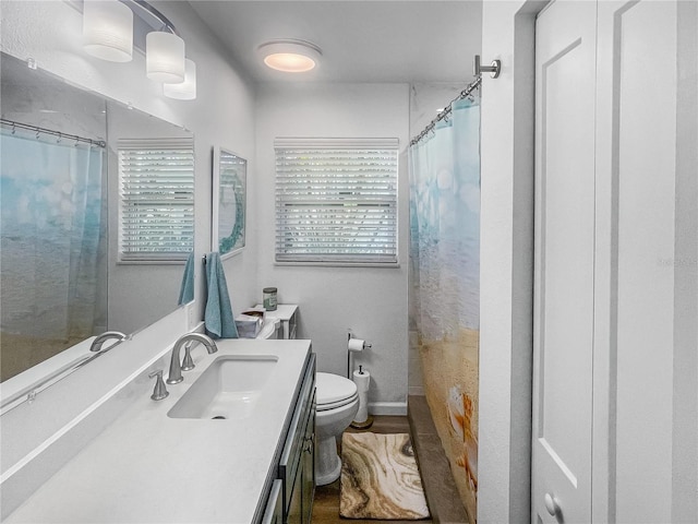 full bathroom featuring toilet, vanity, and a shower with shower curtain
