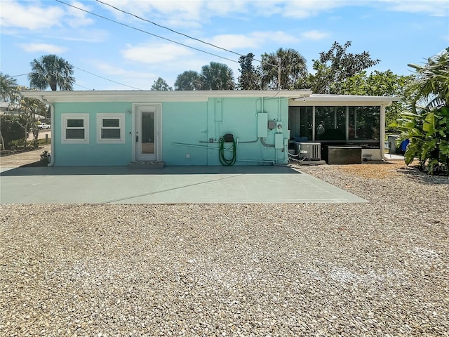 rear view of property with a patio and stucco siding