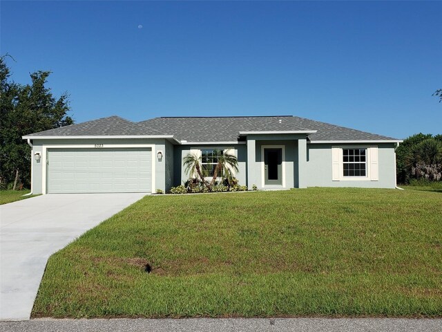 25 Sabot Ct, Placida, FL 33946 - view of front of home featuring a front lawn, a garage, stucco siding, and concrete driveway