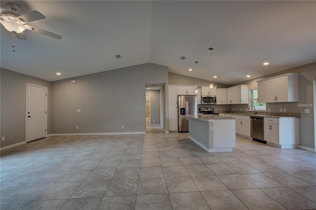 25 Sabot Ct, Placida, FL 33946 - kitchen featuring stainless steel appliances, a center island, vaulted ceiling, white cabinetry, and open floor plan