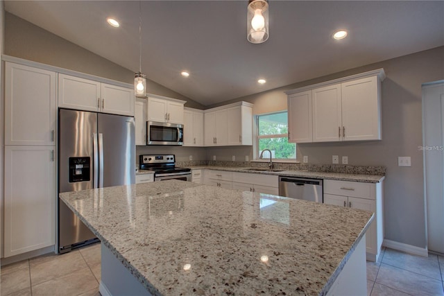25 Sabot Ct, Placida, FL 33946 - kitchen featuring white cabinetry, a sink, appliances with stainless steel finishes, light stone countertops, and vaulted ceiling