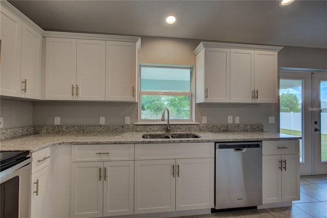 25 Sabot Ct, Placida, FL 33946 - kitchen with white cabinetry, stainless steel appliances, a wealth of natural light, and a sink