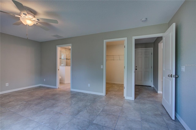 25 Sabot Ct, Placida, FL 33946 - unfurnished bedroom with ceiling fan, visible vents, baseboards, a spacious closet, and ensuite bath