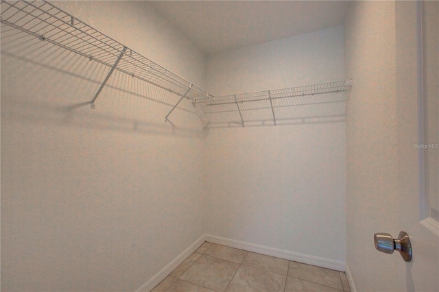 25 Sabot Ct, Placida, FL 33946 - walk in closet with light tile patterned flooring