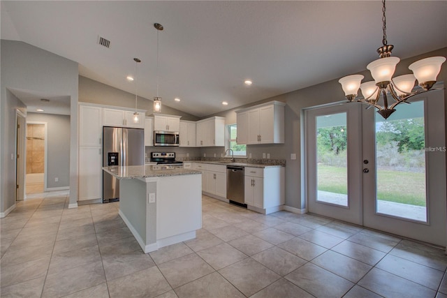 25 Sabot Ct, Placida, FL 33946 - kitchen featuring lofted ceiling, visible vents, stainless steel appliances, and white cabinetry