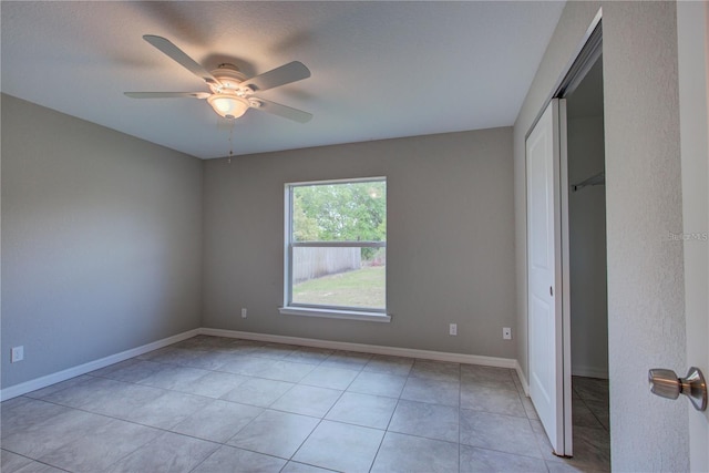 25 Sabot Ct, Placida, FL 33946 - unfurnished bedroom with baseboards, a ceiling fan, light tile patterned flooring, and a closet