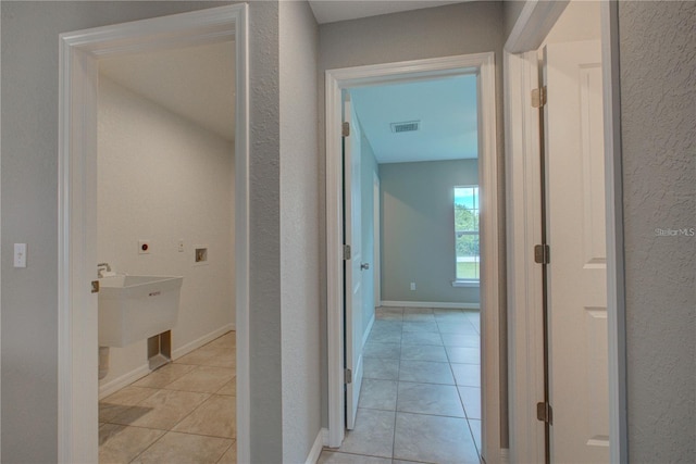 25 Sabot Ct, Placida, FL 33946 - hall featuring light tile patterned floors, a sink, visible vents, and a textured wall