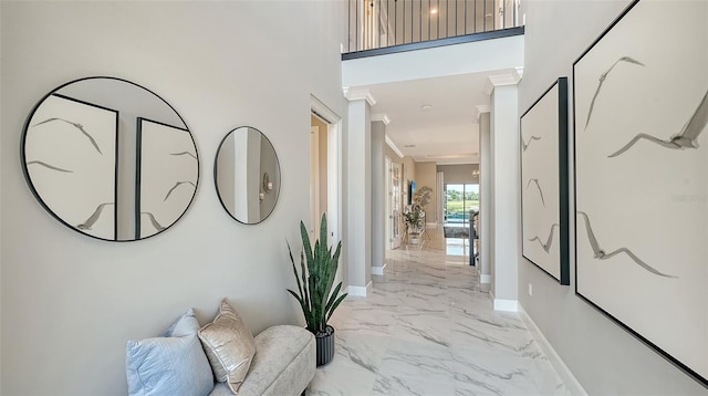 7889 Mainsail Ln, Sarasota, FL 34240 - hallway with light marble finish flooring, baseboards, crown molding, and a towering ceiling