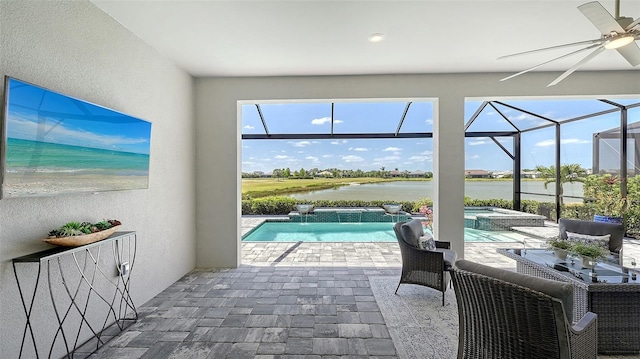 7889 Mainsail Ln, Sarasota, FL 34240 - view of patio / terrace featuring a water view, a ceiling fan, a pool with connected hot tub, and a lanai
