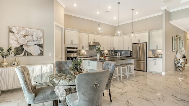 7889 Mainsail Ln, Sarasota, FL 34240 - dining room featuring light marble finish flooring, a high ceiling, crown molding, baseboards, and recessed lighting
