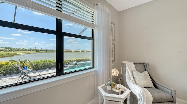 7889 Mainsail Ln, Sarasota, FL 34240 - sitting room with baseboards, a water view, and healthy amount of natural light