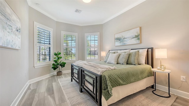 7889 Mainsail Ln, Sarasota, FL 34240 - bedroom with crown molding, wood finished floors, and baseboards
