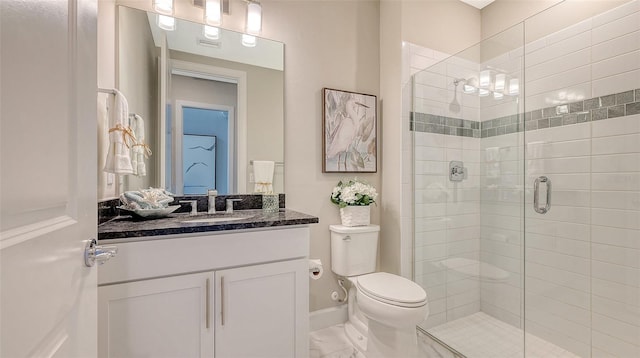 7889 Mainsail Ln, Sarasota, FL 34240 - bathroom with a shower stall, toilet, vanity, and baseboards