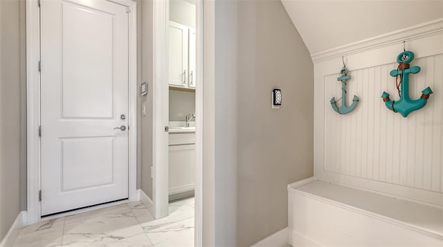 7889 Mainsail Ln, Sarasota, FL 34240 - mudroom with light marble finish floors, baseboards, vaulted ceiling, and a sink