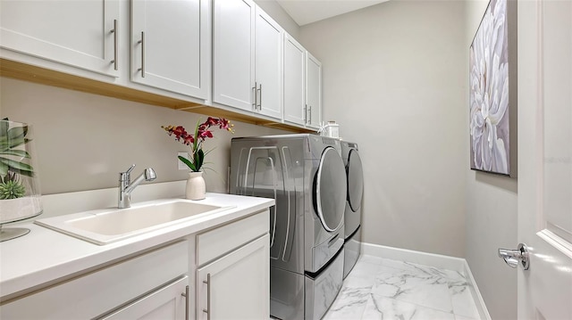 7889 Mainsail Ln, Sarasota, FL 34240 - washroom with washing machine and dryer, light marble finish flooring, cabinet space, and baseboards