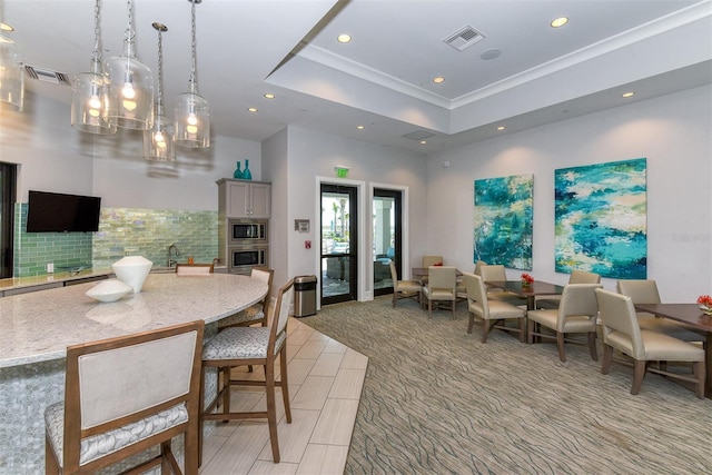 7889 Mainsail Ln, Sarasota, FL 34240 - dining room with recessed lighting, a tray ceiling, and ornamental molding