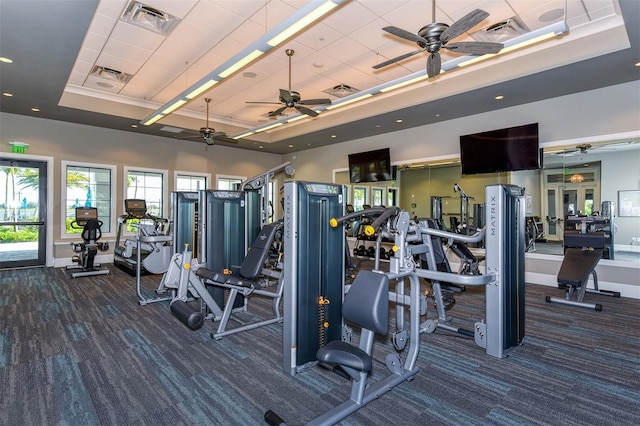 7889 Mainsail Ln, Sarasota, FL 34240 - exercise room with a tray ceiling, ceiling fan, carpet flooring, and baseboards