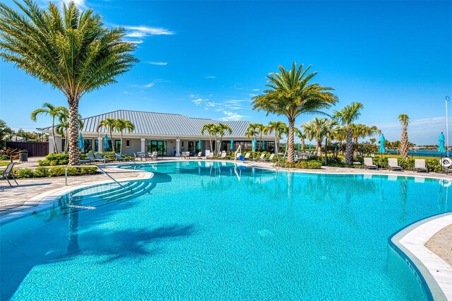 7889 Mainsail Ln, Sarasota, FL 34240 - community pool featuring a patio area