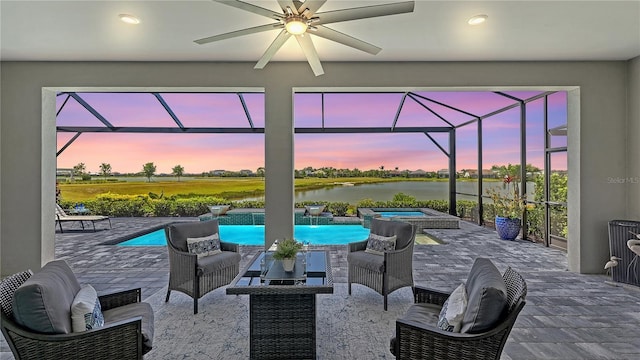 7889 Mainsail Ln, Sarasota, FL 34240 - view of patio featuring an in-ground hot tub, a water view, a lanai, and a ceiling fan
