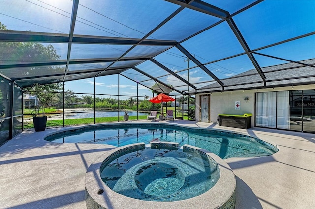 view of pool featuring a patio, a water view, glass enclosure, and a pool with connected hot tub