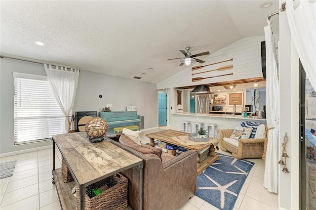 living room featuring a ceiling fan, a textured ceiling, vaulted ceiling, light tile patterned floors, and recessed lighting