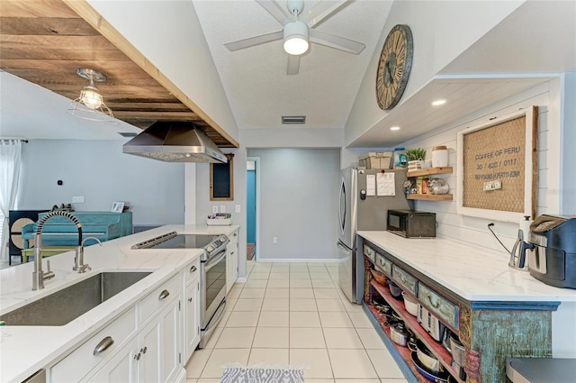 kitchen with white cabinets, appliances with stainless steel finishes, a sink, light tile patterned floors, and visible vents