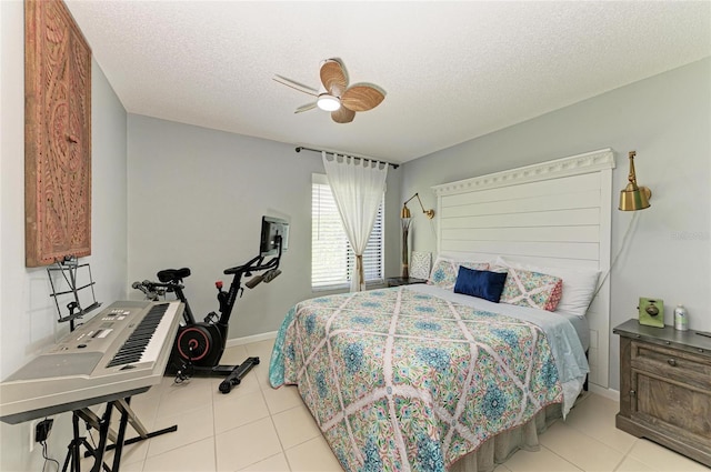tiled bedroom featuring ceiling fan and a textured ceiling