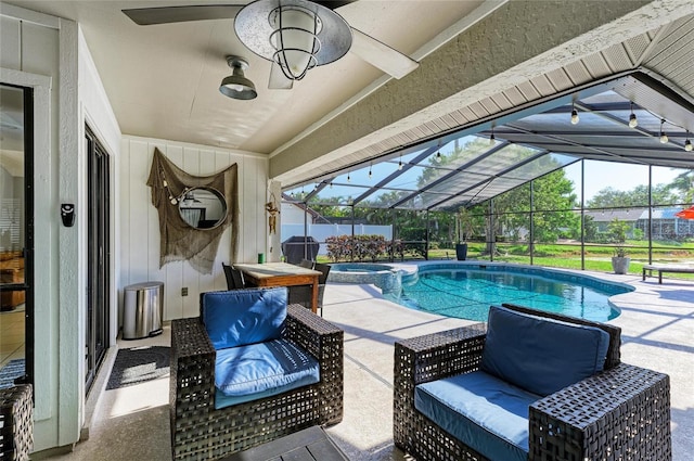 view of swimming pool featuring a patio, glass enclosure, and a pool with connected hot tub