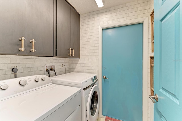 laundry area with cabinet space and washing machine and clothes dryer