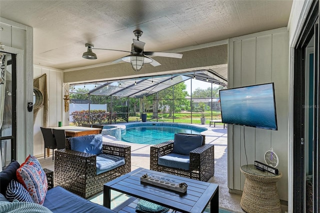 pool featuring an outdoor living space, ceiling fan, a patio area, and a lanai