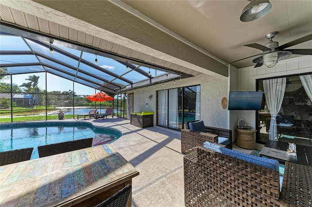 view of patio with ceiling fan, an outdoor pool, and glass enclosure