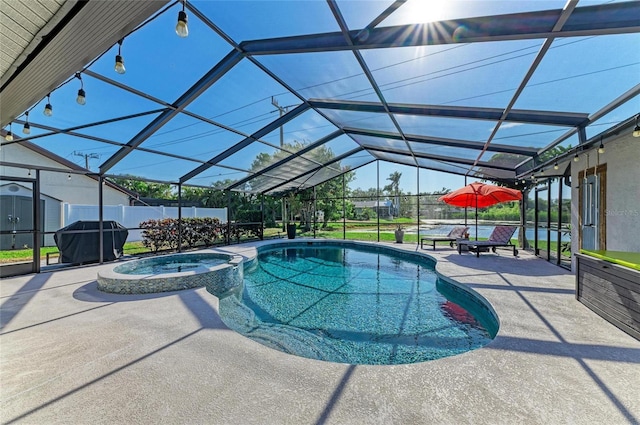 view of swimming pool with a lanai, a patio, a pool with connected hot tub, and area for grilling