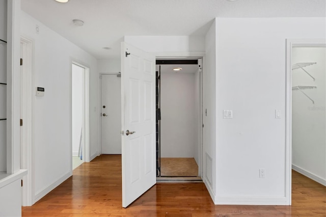 2918 Avenue Ave E, Holmes Beach, FL 34217 - unfurnished bedroom featuring a spacious closet, light wood-style floors, and a closet
