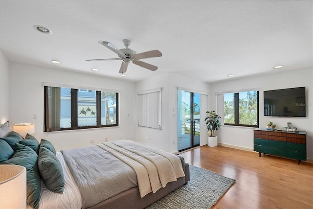 2918 Avenue Ave E, Holmes Beach, FL 34217 - bedroom featuring access to outside, wood finished floors, a ceiling fan, and recessed lighting
