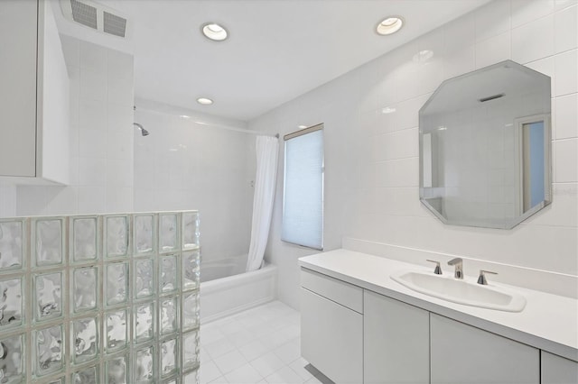 2918 Avenue Ave E, Holmes Beach, FL 34217 - bathroom featuring shower / bath combination with curtain, vanity, tile patterned flooring, recessed lighting, and tile walls
